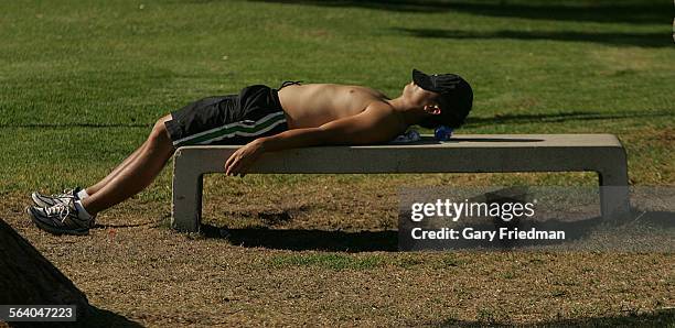 Dai Kim takes a break after a late afternoon jog at the Rose Bowl on friday, 8/25/2006.