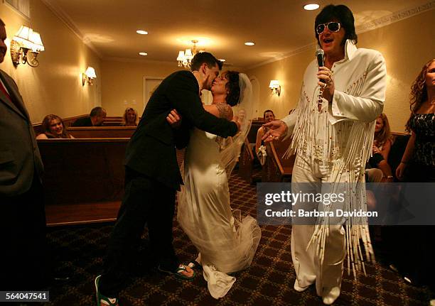 Bianca White hugs and kisses her new husband Jon Andreano both of Denver, as Elvis, Jeff Stanulis, sings Viva Las Vegas following their 2:15 AM...