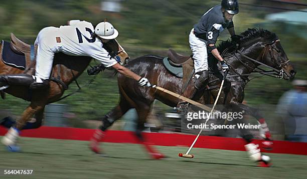 Chasing the ball, Mariano Guitterez, @@#2, Prime Source/Summerland Winery Polo Team player, left, reaches across, crossing staffs, with Tim Rudy,...