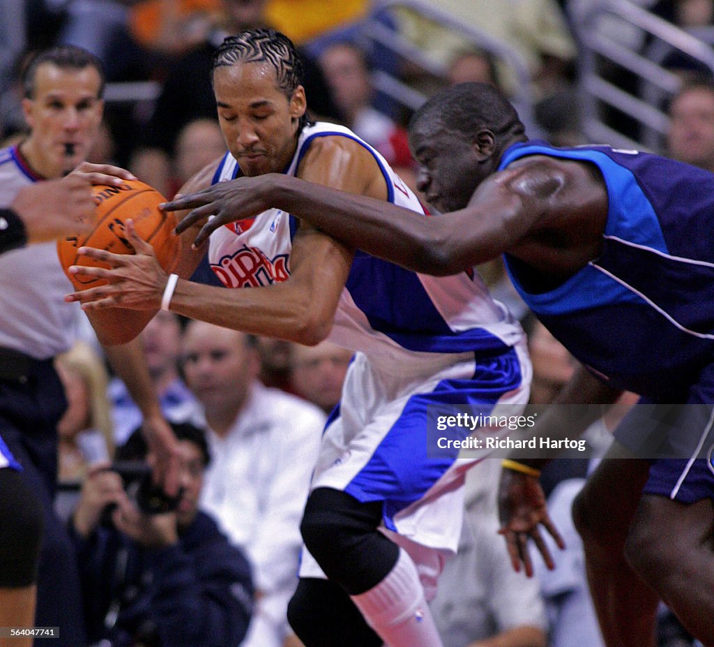 Clipper Shaun Livingston, left, rips the ball away and gets fouled by Dallas Maverick DeSagana Diop