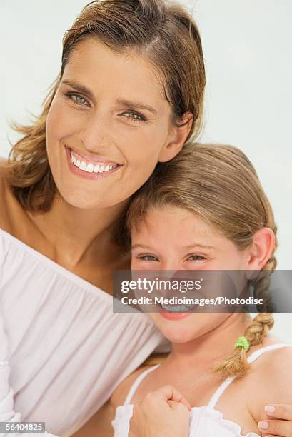 portrait of a mother hugging her daughter - eye color stock pictures, royalty-free photos & images