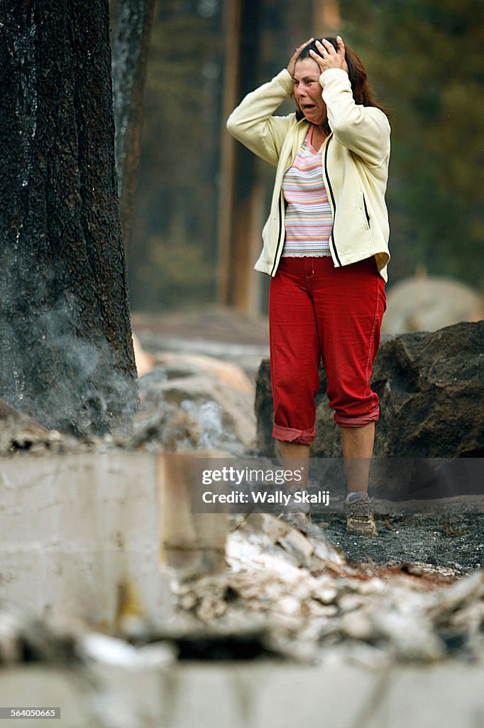 Delicia Spees cries as she looks at the remains of her burned home on Mt. Diablo in South Lake Taho