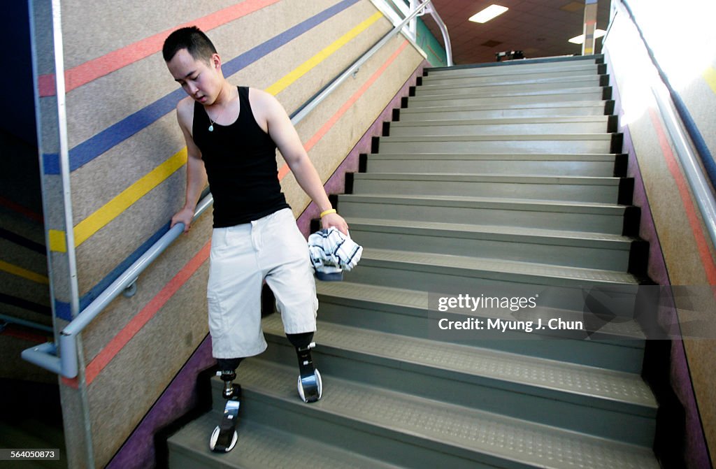 Chang Wong, 23, of Alhambra lost both legs in an IED explosion in Iraq. He is working out again wit