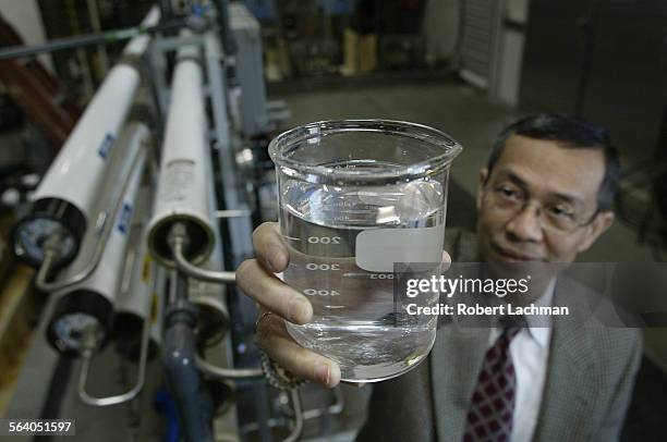 Long Beach, CA) Deim Vuong, assistant general manager of the Long Beach Water Department hold beaker of clean water from the 9000 gallonperday...