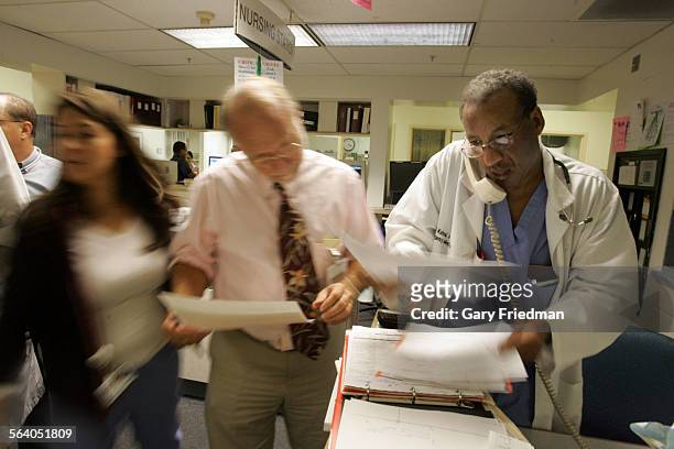 Dr. Daniel Kahsai Dr. Richard Guess , who is the Medical Director, Emergency Services, inside a busy emergency room at the Downey Regional Medical...