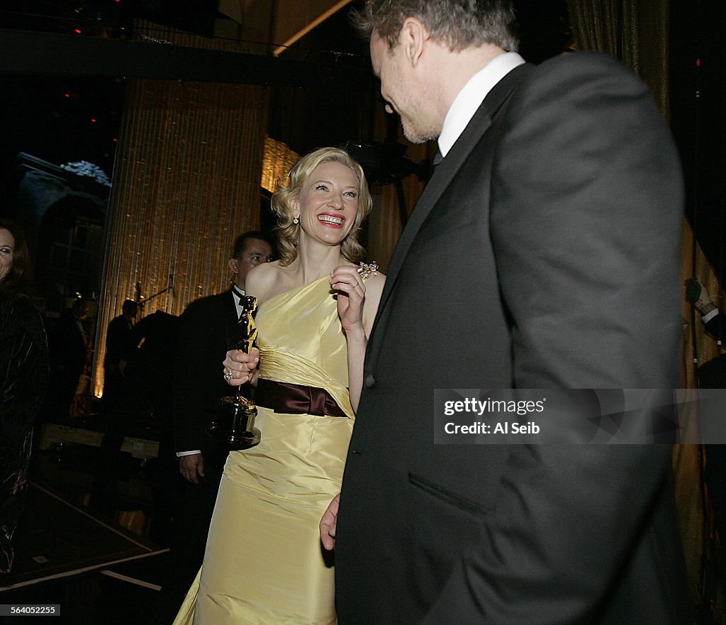 Actress Cate Blanchett reacts backstage with presenter Tim Robbins after she won the Oscar for best