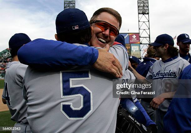 Dodgers Jeff Kent hugs teammate Nomar Garciaparra after the Dodgers clinched the wildcard with a 42 win over the San Francisco Giants AT&T Park in...