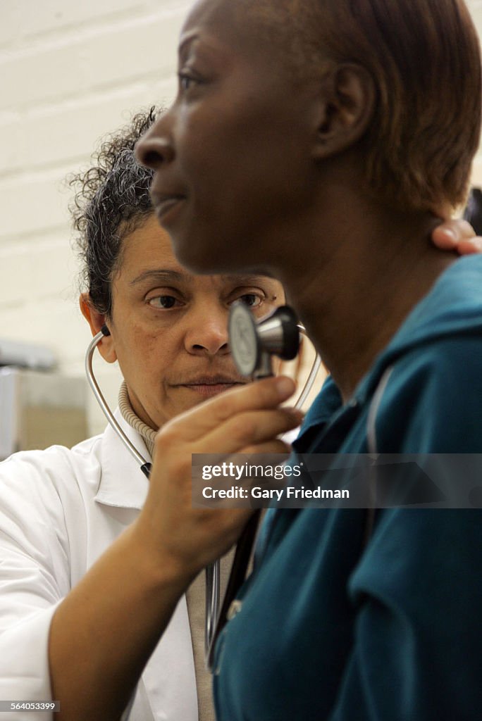 Dora Magana, a family nurse practioner, examines Wanda Jordan, at Clinia Romero on 6/6/2007. Magana