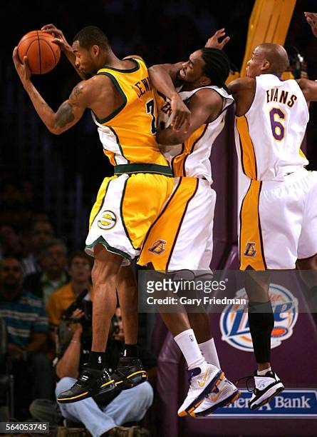 Rashard Lewis of Seattle Supersonics battles for possession with Lakers Ronny Turiaf and Maurice Evans as the Lakers defeat the Seattle Supersonics,...