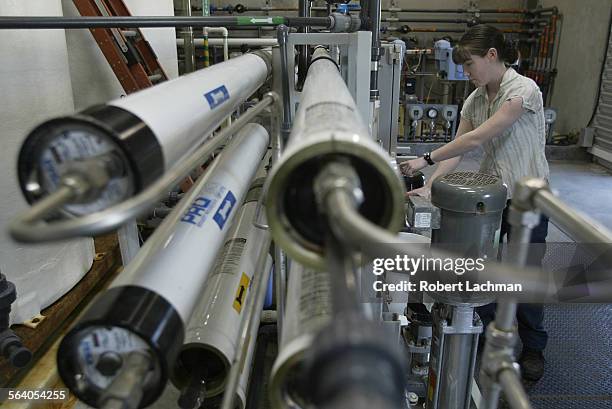 Long Beach, CA) Janel Grebel, civil engineering assistant checks the gauges of the 9000 gallonperday pilot desalination unit at the Long Beach...