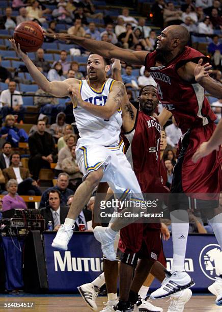 Jordon Farmar scores under the defense of New Mexico State Trevor Lawrence in the second half of UCLA's home opener at Pauley Pavilion Tuesday, Nov....