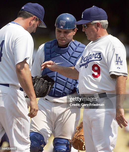 Dodger manager Grady Little grabs the ball away from Jonathan Broxton as catcher Russell Martin looks on 7/26/2006. In the bacground is Dodger...