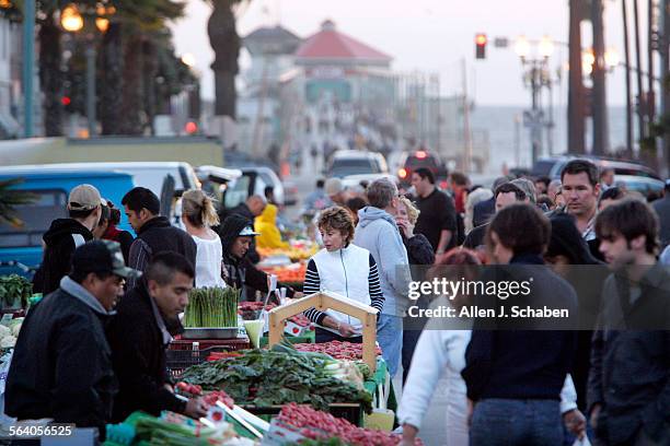 Visitors fill Main Street in Huntington Beach for the city's Surf City Night's, when a portion of the street is closed off to traffic. The event,...