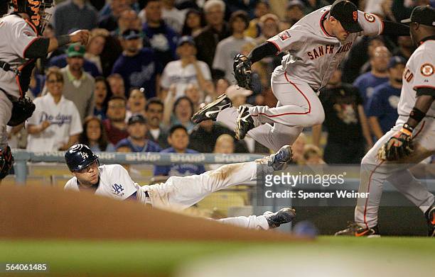 San Francisco Giants pitcher Noah Lowry jumps over Los Angeles Dodgers Russell Martin in the fourth inning of baseball game at Dodger Stadium, April...