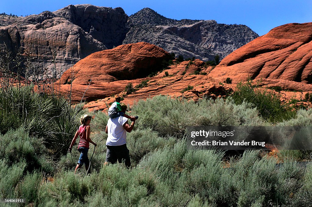 Hikers enjoy a trail at Snow Canyon State Park, which features Red Navajo sandstone, capped by an o