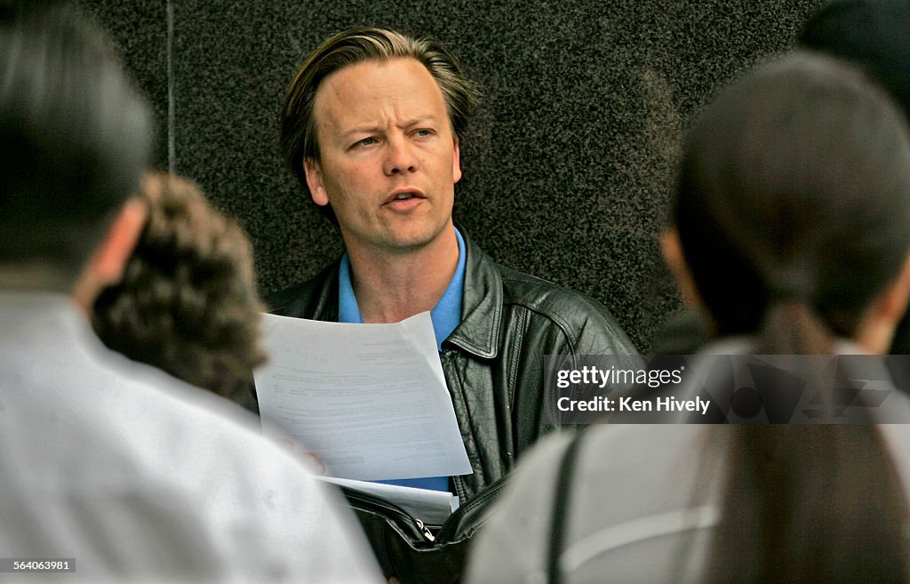 Photo of Kyle Speer, conducting auction on court steps. Story about how the vultures are circling n