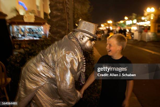 "Automatic", The Silver Robot entertains Evan Athey of Huntington Beach along Main Street Tuesday, March 27, 2007 in Huntington Beach. Main Street is...
