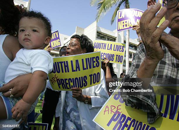 Nasir Hamilton, 10 months, listens as representatives from SEIU Local 660 spoke at Martin Luther King Jr./Drew University Medical Center to protest...