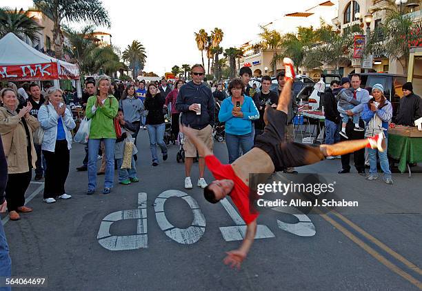 Pedestrians cheer for Phillip "Speed" Albuquerque, of Los Angeles, performs BBoying/Breakdancing with his group Infamous Squad, on Main Street...
