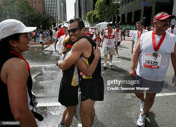 Miguel Rodriguez embraces his running partner Miriam Ruiz at the finishline of the 22nd Annual Los Angeles Marathon, March 4, 2007.