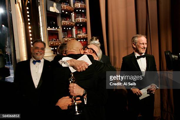 Martin Scorsese, is hugged by Jack Nicholson, as Francis Ford Coppola, left, and Steven Spielberg, right, look on back stage during the 79th Annual...