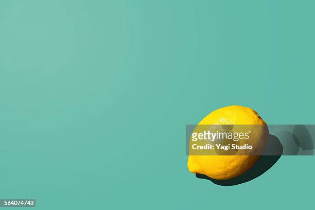 lemon - food on coloured background stock pictures, royalty-free photos & images