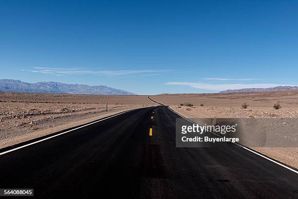 One of many long, straight, black roads in California Death Valley