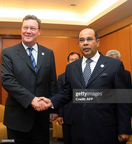 Malaysian Foreign Minister Seri Syed Hamid Albar welcomes his Australian counterpart Alexander Downer prior to their bilateral meeting on the...