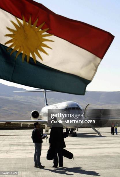 Plane seen behind a Kurdistan flag just upon its arrival, 10 December 2005, in Suleimaniya airport, northern Iraq. A private budget airline, Fly air,...