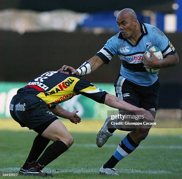 Jonah Lomu of Cardiff hands off Calvisano's Emiliano Mulieri during the Heineken European Cup match between Calvisano and Cardiff Blues at the San...