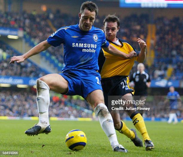 John Terry of Chelsea holds off David Connolly of Wigan Athletic during the FA Barclays Premiership match between Chelsea and Wigan Athletic at...