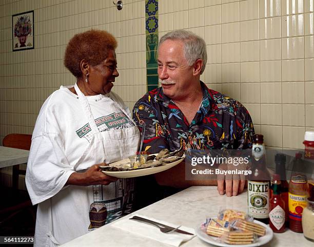 New Orleans writer and television personality Ronnie Virgets is served the house specialty, ice-cold oysters on the half shell, by Alma Griffin at...