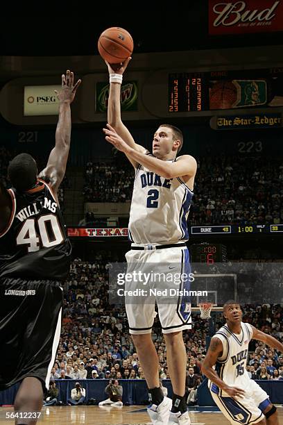 Josh McRoberts of the Duke University Blue Devils shoots against Mike Williams of the University of Texas Longhorns at the Continental Airlines Arena...