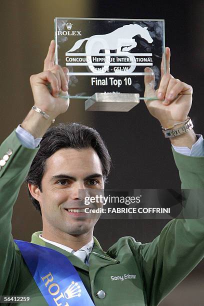 Brazilian Rodrigo Pessoa holds the trophy after he rode Baloubet du Rouet to win the fifth FEI World Top 10 final, during the 45th CSI-W...