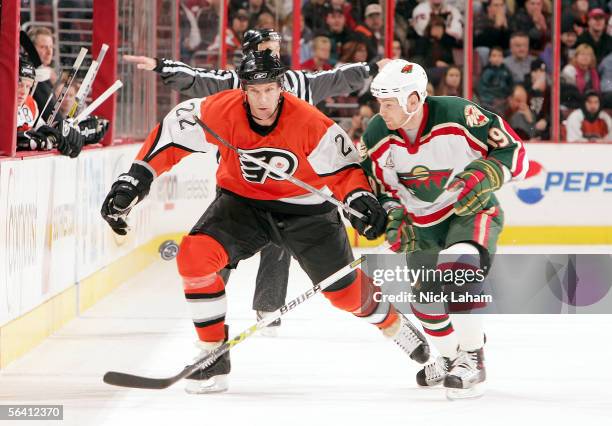 Stephane Veilleux of the Minnesota Wild challenges Mike Knuble of the Philadelphia Flyers on December 10, 2005 at Wachovia Center in Philadelphia,...