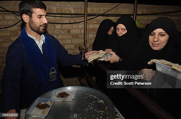 Women pilgrims receive food at the Jamkaran Mosque December 6, 2005 in Jamkaran, Iran. Some Iranian Shiites believe and are waiting for the return of...