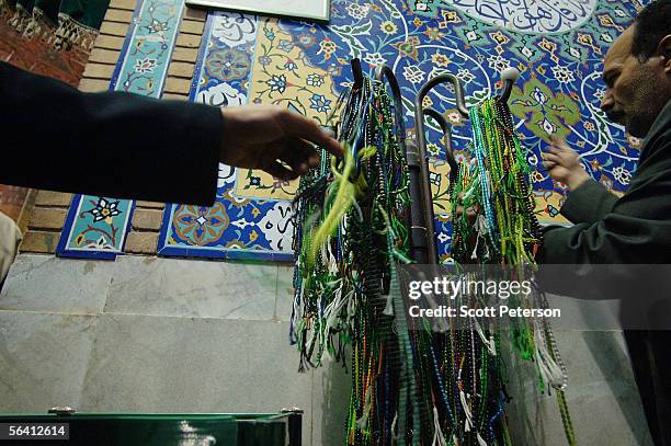 Devotees choose strings of prayer beads, outside the Jamkaran Mosque December 6, 2005 in Jamkaran, Iran. Some Iranian Shiites believe and are waiting...