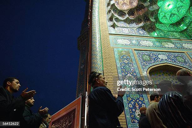 Iranian Shiites spill oustside of the Jamkaran Mosque to pray December 6, 2005 in Jamkaran, Iran. Some Iranian Shiites believe and are waiting for...