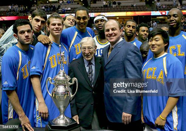The UCLA Bruins stand with John Wooden after defeating the Nevada Wolf Pack 67-56 during the 12th Annual John R. Wooden Classic on December 10, 2005...
