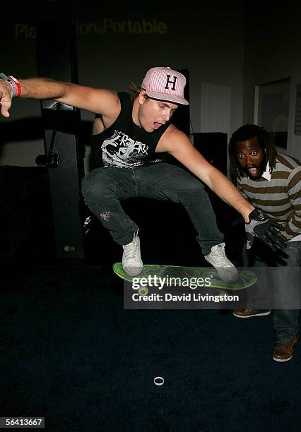 Skateboarder Chad Muska performs a trick as Sal Masekela looks on as they attend Playstation BANDtogether, a benefit presented by Sony Computer...