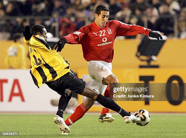 Mohamed Aboutrika of Al Ahly and Redha Tukar of Al Ittihad in action during the FIFA Club World Championship Toyota Cup Japan 2005 the first round...