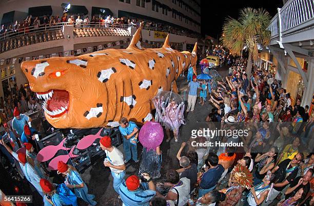 In this handout photo, a float with a giant shark, themed "The Life Aquatic," rolls down Duval Street late during the Fantasy Fest Parade December...
