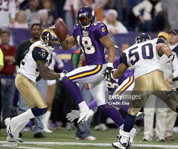 Koren Robinson of the Minnesota Vikings runs past Pisa Tinoisamoa of the St. Louis Rams to score a touchdown on December 11, 2005 at the Hubert H....