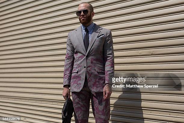 Julius LaCour is seen attending the Nick Graham, Kenneth Ning & John Elliott presentations wearing a suit and bag by his own design with Thom Browne...