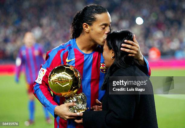 Ronaldinho of Barcelona kisses his mother as he holds the Ballon D'Or award for European Footballer of the Year on the pitch before the Primera Liga...