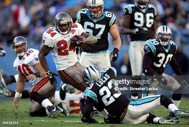 Carnell Williams of the Tampa Bay Buccaneers runs with the ball against the Carolina Panthers on December 11, 2005 at Bank of America Stadium in...