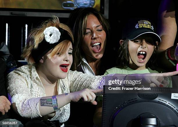 Singer Kelly Osbourne, actress Krista Allen and her son Jake Moritt are seen onstage during Playstation BANDtogether, a benefit presented by Sony...