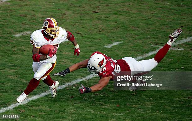 Running back Clinton Portis of the Washington Redskins runs around defensive end Chike Okeafor of the Arizona Cardinals during the first half of the...