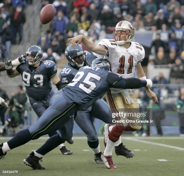 Quarterback Alex Smith of the San Francisco 49ers is tackled by defensive end Rodney Bailey of the Seattle Seahawks in the second half of the 49ers'...