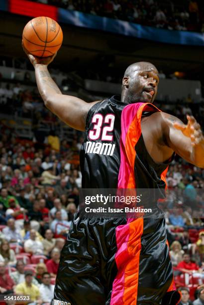 Shaquille O'Neal of the Miami Heat grabs a rebound against the Washington Wizards on December 11, 2005 at American Airlines Arena in Miami, Florida....
